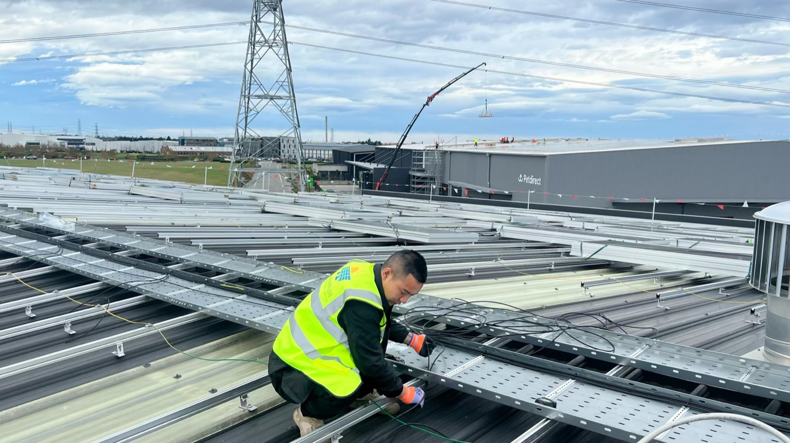 Generations Energy installer fixing mounting rails on a commercial roof